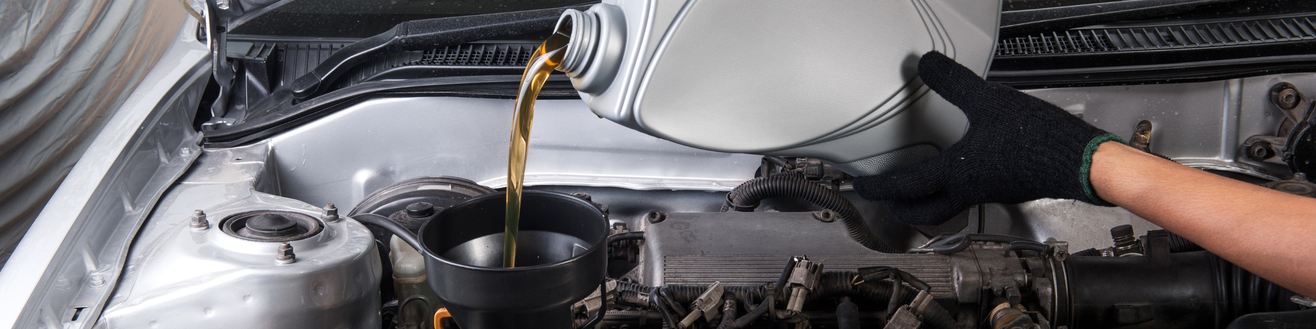 Engine oil getting poured into a vehicle